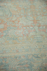 Distressed vintage Mahal pile, showing mostly even wear with faded blush, blue, and beige floral motifs.