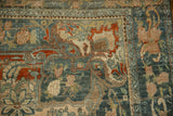 Distressed vintage Bijar rug with teal and brick red vinery, checkered lily border.