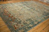 Distressed vintage Bijar rug detail with worn brick red, dusty teal floral motifs.