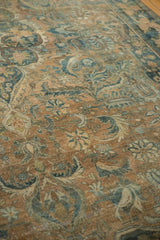 Distressed Persian Bijar carpet detail with sprawling floral vinery and abrashed coffee brown ground.