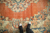 Soft terracotta patina on a distressed Arak rug with sand and dusty blue floral motifs.