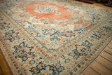 Vintage Arak carpet corner showing the wide navy blue border and distressed low-pile texture.
