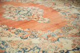 Abrashed terracotta field of a distressed Arak carpet showing mostly even wear to the pile.