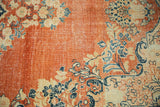 Detail of distressed Arak carpet showing worn pile and foundation on the terracotta field.