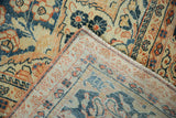 Folded corner of a vintage Arak carpet, revealing the distressed pile and hand-knotted weave.