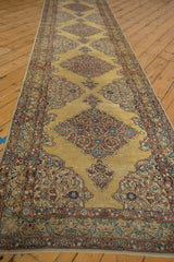 Angled view of a long Persian runner highlighting its repeating diamond medallions and arabesques.