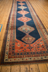 Angled view showing the single column of serrated medallions on an antique Bijar runner.