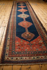 A long perspective view of an antique Bijar runner's central column of geometric medallions.