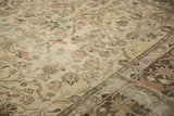 Detail of a distressed Lilihan carpet's faded beige field and Herati arabesque border.