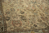 Distressed vintage Lilihan carpet detail, spiral arabesque main border and faded floral field.