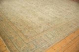 Angled perspective of a vintage Kerman rug's sprawling floral arabesques.