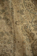 Worn, hand-knotted pile of a vintage Kerman carpet with visible foundation and soft drape.