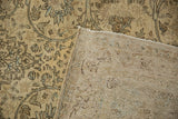 Folded corner of a vintage Kerman rug reveals its hand-knotted foundation and tight weave.