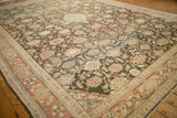 A vintage Mahal carpet corner showing the detailed floral field against the multi-toned Herati border.