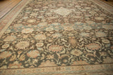 Heavy color abrashes across the intricate floral field of a distressed vintage Mahal carpet.
