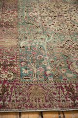 Distressed Persian Tabriz rug's raspberry red weeping willow border and ocean green field.