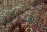 Distressed pile of vintage Tabriz rug revealing faded ocean green and raspberry floral patterns.