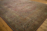 Distressed vintage Meshed rug border and field with time-softened floral palmettes and vines.
