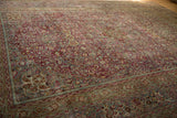 Distressed Meshed pile with raspberry and dusty blue arabesques and palmette border motifs.