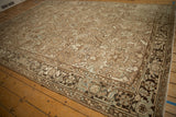 Angled view of a vintage Mehrivan carpet showing its Turtle Samovar border pattern.