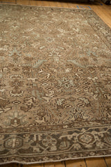 Angled view showing the distressed texture and geometric patterns in beige and slate blue on a Mehrivan carpet.