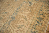 The classic Turtle Samovar border and geometric floral motifs on a distressed vintage Heriz rug.