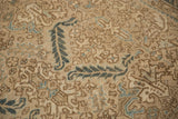 Detailed view of the distressed Heriz carpet's weave showing tiered leaf and floral motifs.