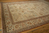 Traditional Persian Kashan carpet corner, displaying madder red floral border and worn palmette field.