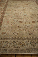 Distressed vintage Kashan carpet showing faded floral palmettes and subtle vinery details.