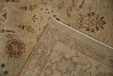 Distressed vintage Kashan rug showing pile texture, muted floral details, and woven foundation.