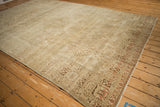 Distressed vintage Persian Joshegan rug corner, highlighting heavy abrashes and faded lattice floral guls.