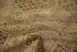 Faded floral patterns and heavy abrashes on the distressed pile of this vintage Joshegan rug.