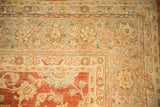 Distressed Kashan carpet corner showing faded field palmettes meeting floral border motifs.