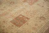 Vintage Tabriz carpet's blossomed plant motifs on distressed ivory and rust panels.