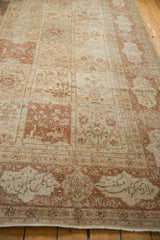 Vintage distressed Tabriz rug corner with Persian inscription motif and natural wear.