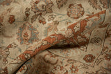 A vintage Tabriz carpet folded to display the low-pile texture and terracotta floral pattern details.