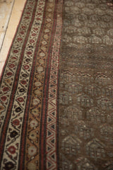 Distressed vintage Kurdish runner texture, with geometric borders and time-softened shades.