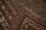 Vintage distressed Kurdish runner folded corner showing machine binding, geometric border.