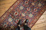 A view from above the rich, gem-toned henna pattern of a vintage Malayer runner.