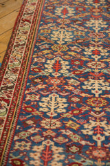 Geometric serrated leaf border and henna plant motifs on a vintage Persian Malayer runner.