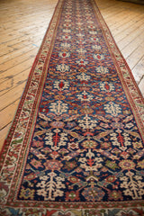 Perspective view of a vintage Malayer runner highlighting its allover henna plant design.