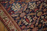 Short pile and hand-knotted texture of a vintage Malayer rug's henna and leaf motifs.