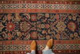 Close view of the Herati pattern showing time-softened wear and exposed foundation on an antique Malayer rug.