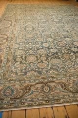 Detailed view of distressed Malayer carpet, showing dusty teal, beige floral patterns and soft wear.