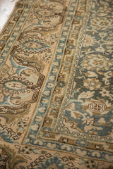 Distressed Malayer carpet pile, highlighting even wear to knot heads and dusty teal floral motifs.
