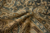 Worn pile texture of vintage Malayer carpet with dusty teal and beige floral designs.