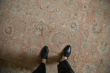 Distressed vintage Tabriz rug, worn rose and slate blue scrolled floral patterns.