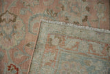 Close-up of distressed vintage Tabriz carpet showing hand-knotted back, fringed edge, and floral pile.