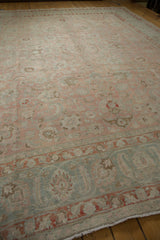 Distressed rose and slate blue floral field with partial Herati style border motif detail.
