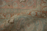 Softened pile of a distressed Tabriz carpet with muted rose, slate blue, and ivory Herati patterns.
